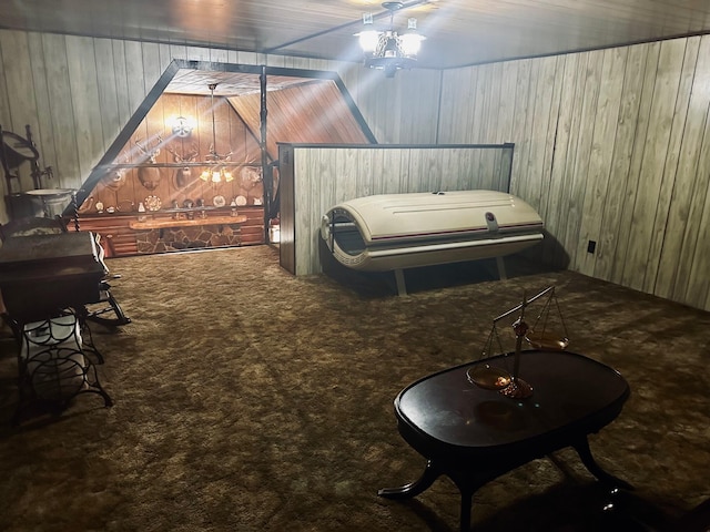 carpeted bedroom with wooden walls