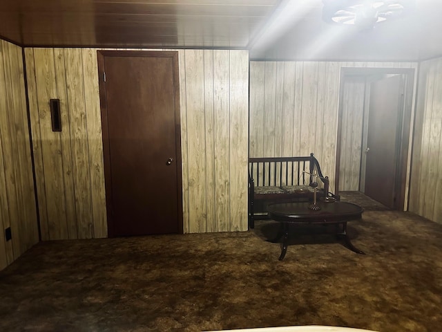 bedroom featuring carpet floors and wooden walls