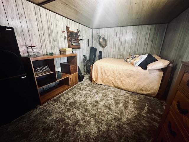 carpeted bedroom featuring wooden ceiling and wooden walls