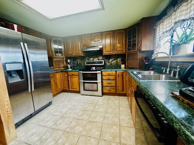 kitchen with light tile patterned flooring, stainless steel appliances, backsplash, and sink