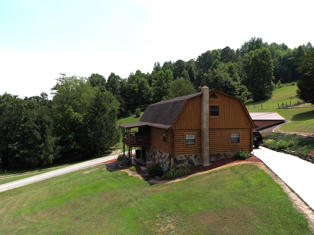 view of side of home with a yard