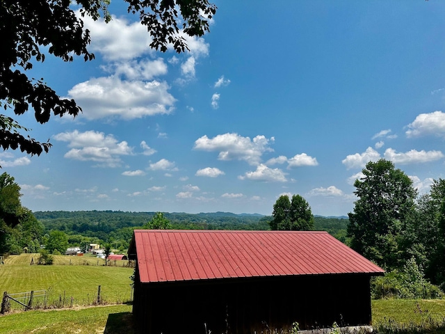 exterior space featuring a rural view and a yard