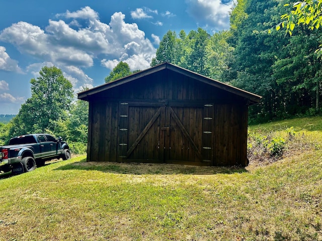 view of outdoor structure featuring a lawn