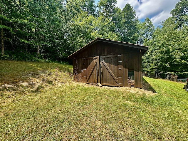 view of outbuilding featuring a lawn