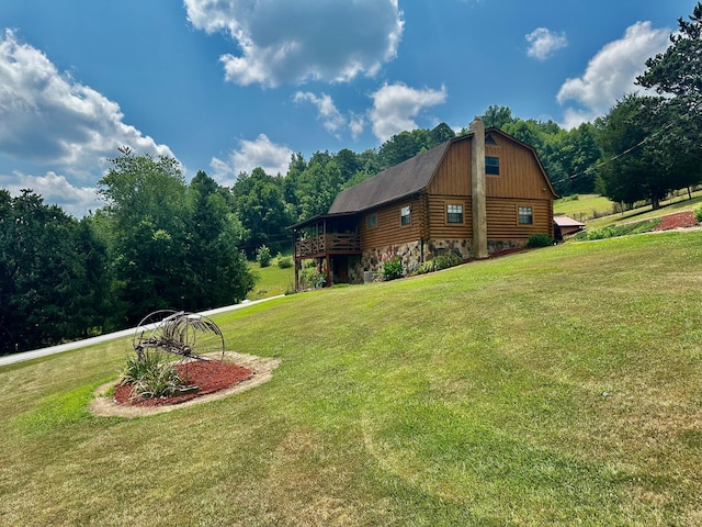 view of side of home with a yard