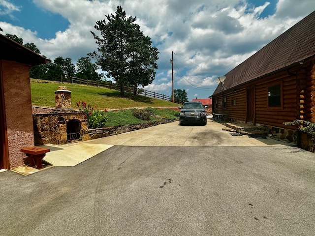 view of yard featuring an outdoor stone fireplace