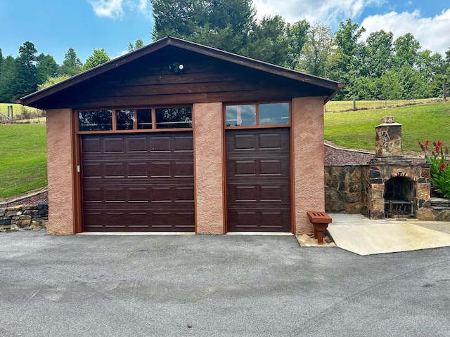 garage featuring a lawn