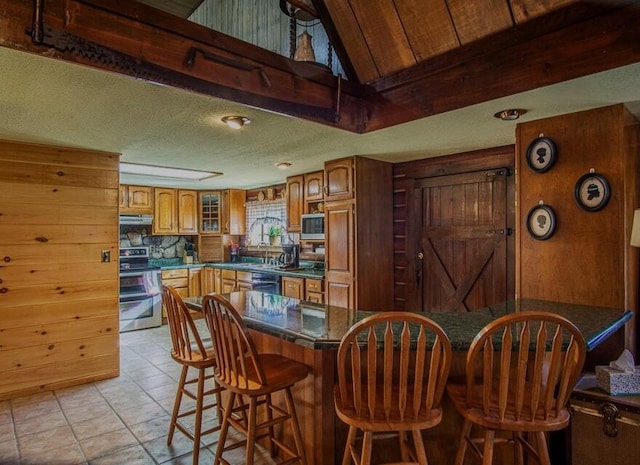 dining space featuring wood walls and light tile patterned flooring