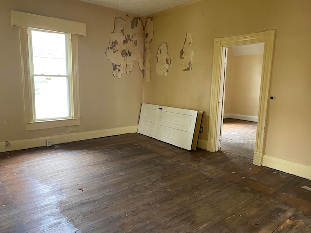 spare room with dark hardwood / wood-style flooring