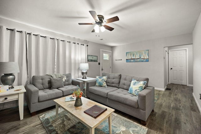 living room featuring ceiling fan and dark hardwood / wood-style flooring