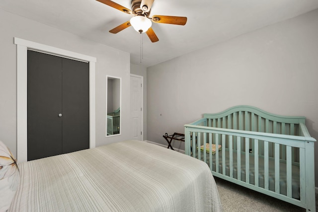 carpeted bedroom featuring ceiling fan and a closet