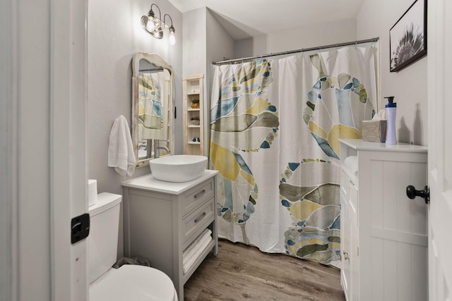 bathroom with vanity, wood-type flooring, walk in shower, and toilet