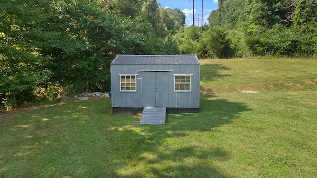 view of outbuilding with a lawn