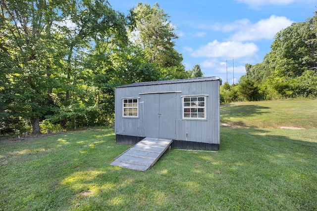 view of outdoor structure featuring a lawn