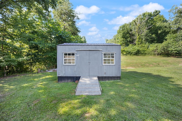 view of outbuilding with a yard