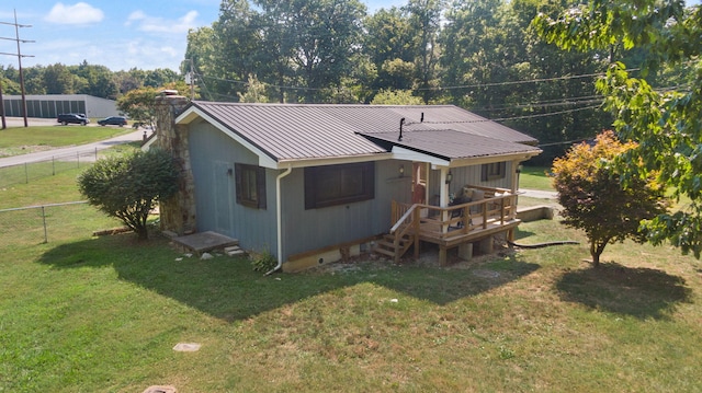 rear view of property with a yard