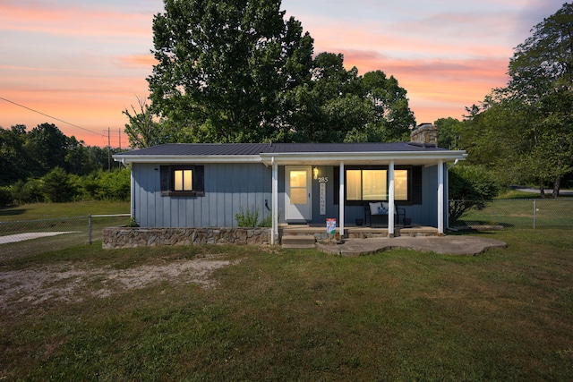 view of front facade featuring a yard and covered porch