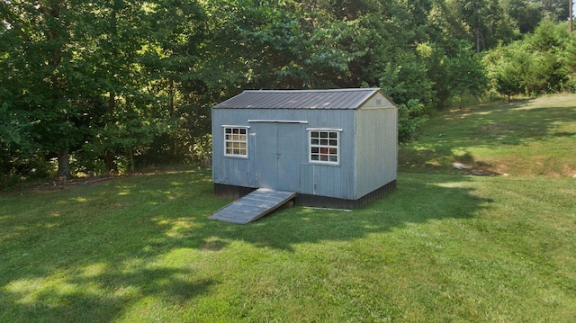 view of outbuilding with a yard