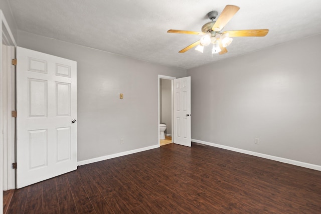 unfurnished bedroom featuring a ceiling fan, a textured ceiling, baseboards, and dark wood-type flooring