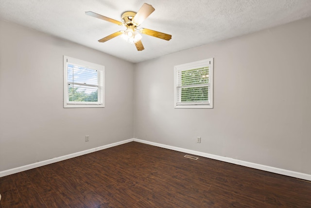 empty room featuring visible vents, ceiling fan, a textured ceiling, wood finished floors, and baseboards