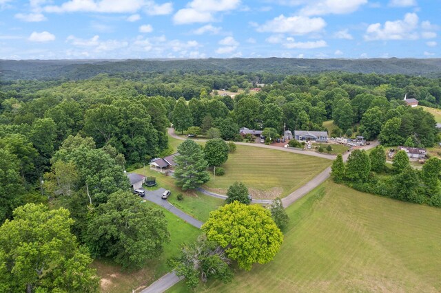 birds eye view of property with a forest view