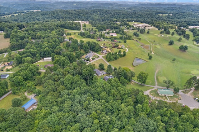 bird's eye view featuring view of golf course and a forest view