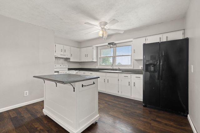 kitchen with dark countertops, white cabinets, electric range, and black fridge