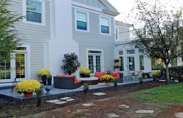 rear view of house with a patio and a balcony