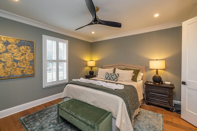 bedroom featuring crown molding, dark hardwood / wood-style floors, and ceiling fan