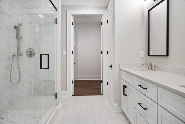 bathroom with walk in shower, wood-type flooring, and vanity