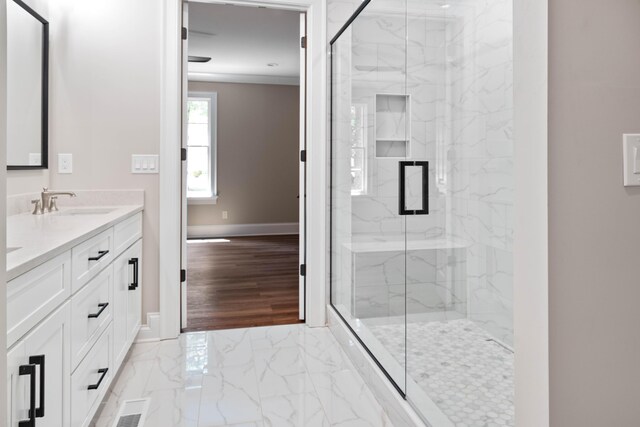 bathroom featuring tile patterned floors, a shower with door, and vanity