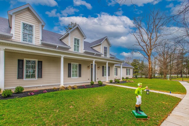 cape cod-style house featuring a porch and a front yard