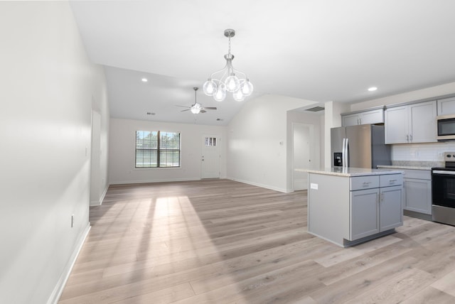 kitchen featuring electric range, light hardwood / wood-style flooring, tasteful backsplash, a kitchen island, and stainless steel fridge