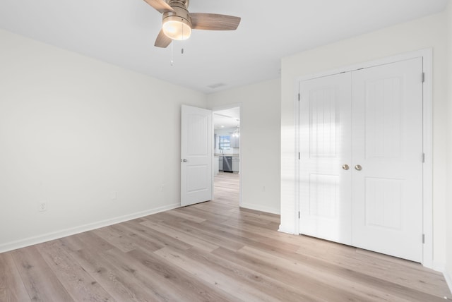 unfurnished bedroom featuring a closet, ceiling fan, and light wood-type flooring