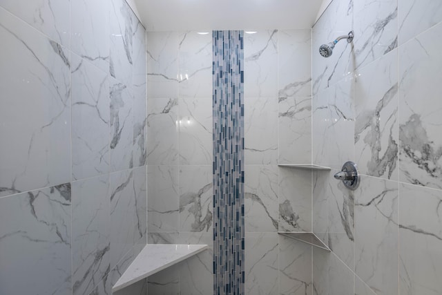 bathroom with tiled shower