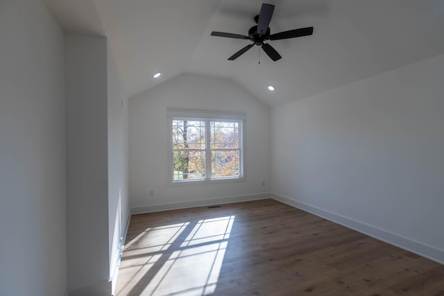 spare room with dark wood-type flooring, ceiling fan, and lofted ceiling