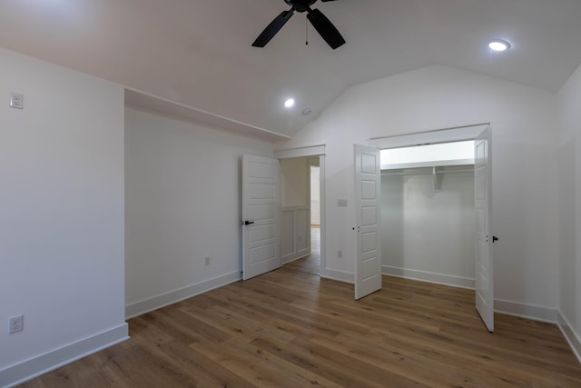 unfurnished bedroom featuring a closet, ceiling fan, vaulted ceiling, and hardwood / wood-style floors