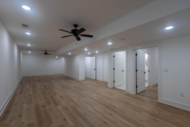 basement featuring light hardwood / wood-style floors and ceiling fan