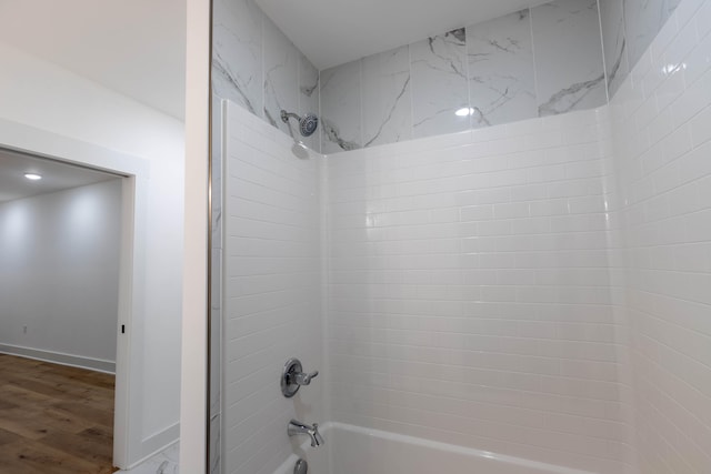 bathroom featuring tiled shower / bath and hardwood / wood-style floors