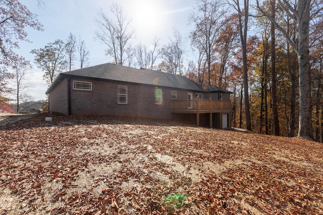 back of property featuring a wooden deck