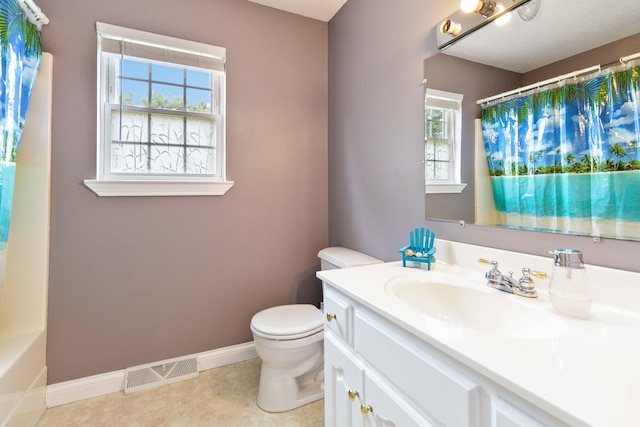 bathroom featuring tile patterned floors, vanity, and toilet