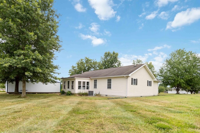 back of property with cooling unit and a yard