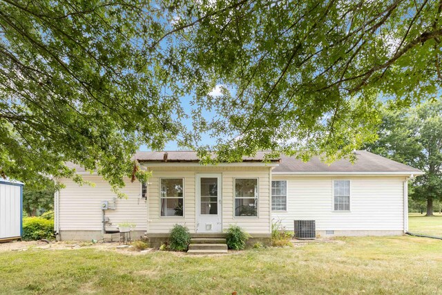 ranch-style house with central AC and a front yard