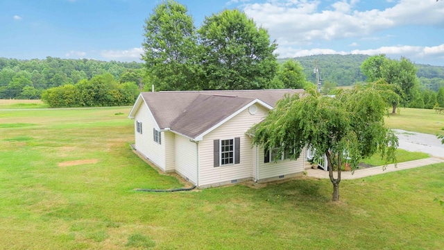 view of side of home with a lawn