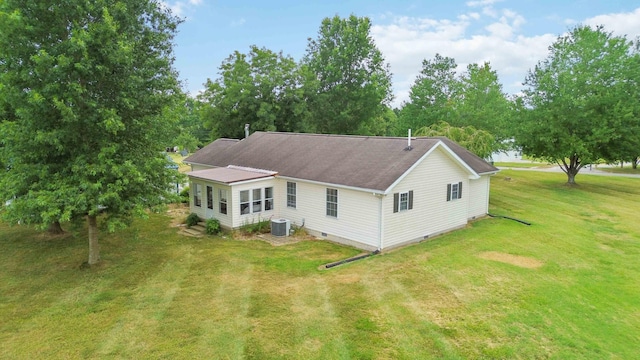 view of property exterior with central AC and a yard