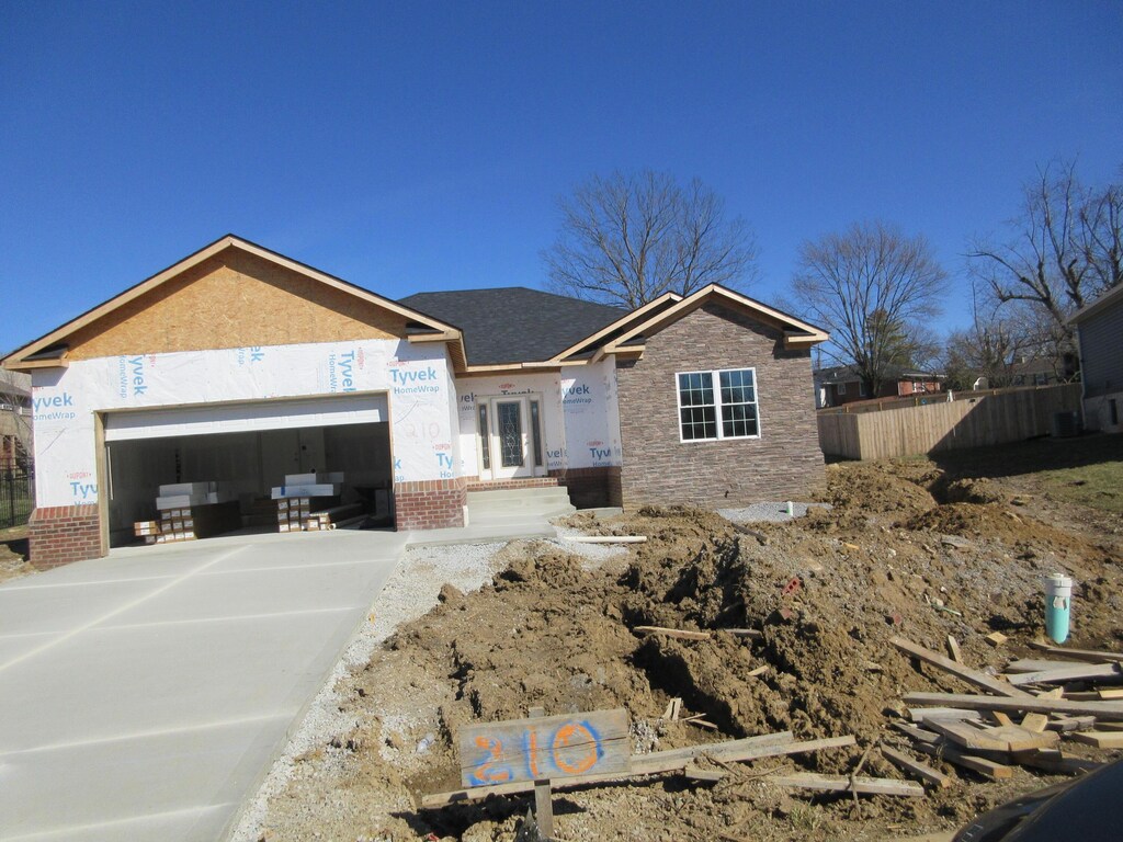 view of property exterior featuring a garage and central air condition unit