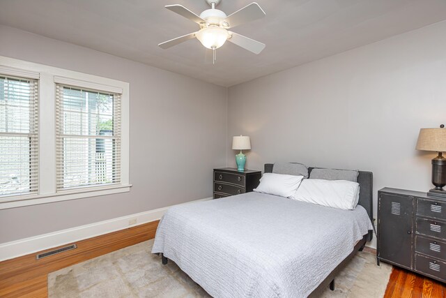 bedroom with ceiling fan and hardwood / wood-style floors