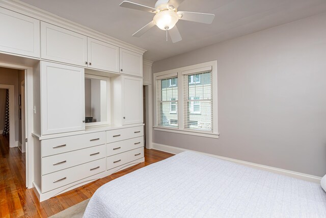 bedroom with a closet, light wood-type flooring, and ceiling fan