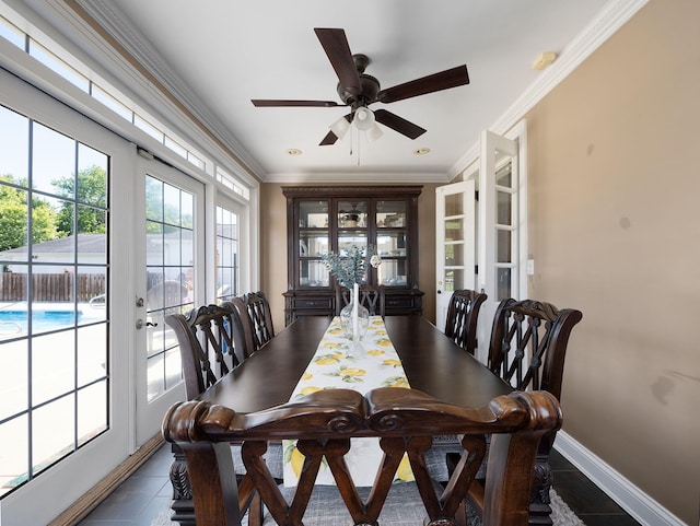 dining room with french doors, dark tile patterned flooring, ceiling fan, and ornamental molding