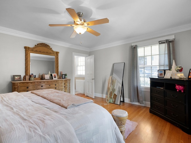 bedroom with ceiling fan, light hardwood / wood-style floors, and crown molding